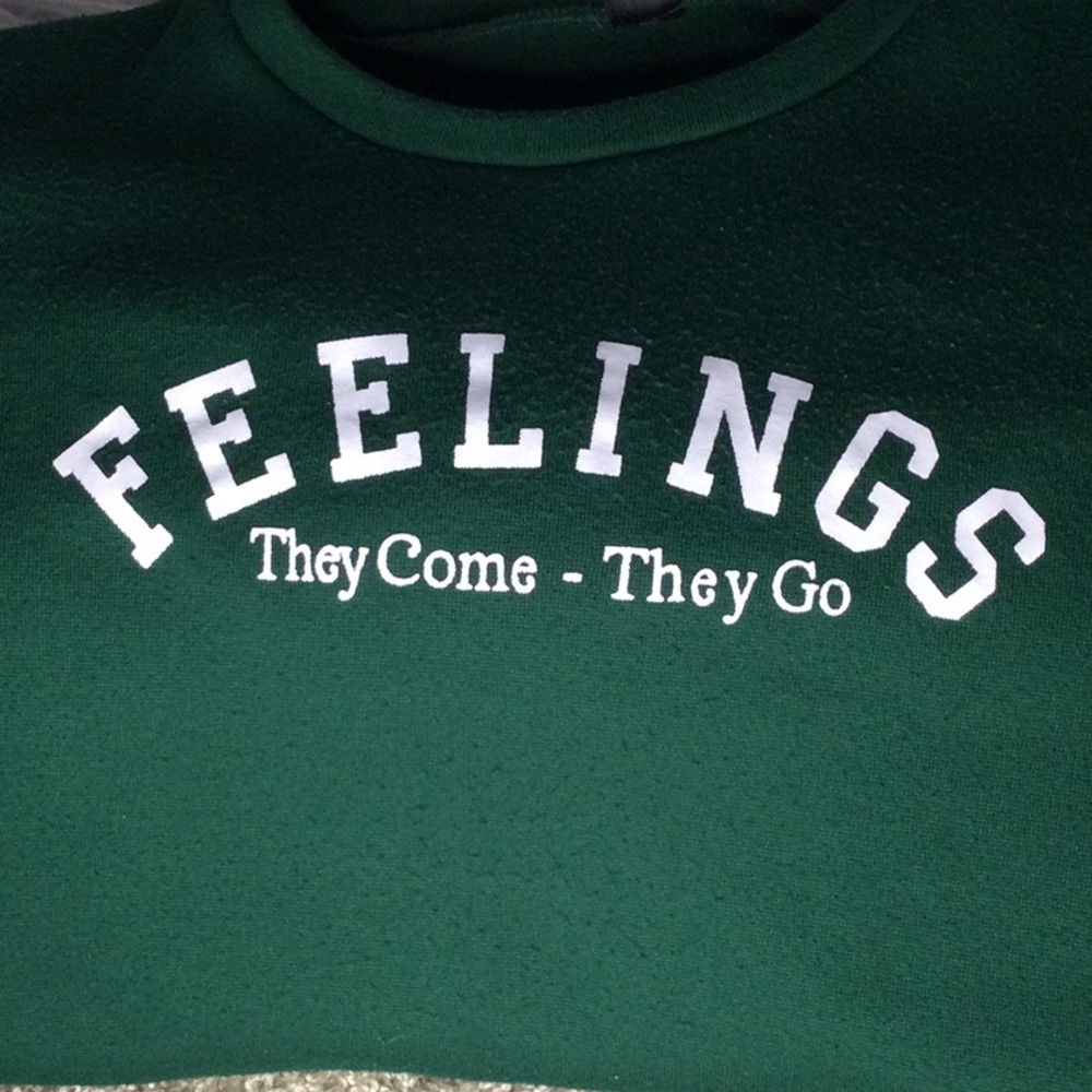 Green pull over sweatshirt that has been worn